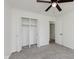 Bedroom with carpeting, ceiling fan and a double closets, offering ample storage at 11230 N College Ave, Carmel, IN 46032