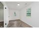 Bright bedroom with luxury vinyl plank flooring and a double set of windows, offering ample natural light at 11230 N College Ave, Carmel, IN 46032