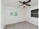 Bedroom with a ceiling fan, two windows, and plush gray carpet at 11230 N College Ave, Carmel, IN 46032