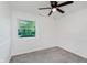 Bright bedroom with neutral carpet and a ceiling fan, offering a comfortable space at 11230 N College Ave, Carmel, IN 46032