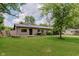 Charming single-story home with well-manicured lawn and mature shade trees at 11230 N College Ave, Carmel, IN 46032