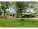 Charming single-story home with well-manicured lawn and mature shade trees at 11230 N College Ave, Carmel, IN 46032