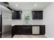 Modern kitchen featuring stainless steel appliances and sleek dark cabinetry at 11230 N College Ave, Carmel, IN 46032