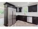 Modern kitchen with stainless steel appliances and sleek dark cabinetry at 11230 N College Ave, Carmel, IN 46032