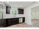 Modern kitchen featuring stainless steel appliances and sleek dark cabinetry at 11230 N College Ave, Carmel, IN 46032