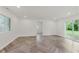 Bright living room featuring new flooring, natural light, and a sliding glass door at 11230 N College Ave, Carmel, IN 46032