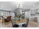 A bright, airy dining area features a round table and chandelier, seamlessly connected to the kitchen and living room at 1141 W 35Th St, Indianapolis, IN 46208