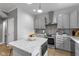 Modern kitchen with grey cabinets, a center island, and stainless steel appliances at 1141 W 35Th St, Indianapolis, IN 46208