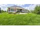 Expansive backyard featuring manicured lawn, fenced perimeter, and patio area with seating at 11626 Laurel Springs Cir, Noblesville, IN 46060
