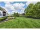 Spacious backyard with lush lawn, fence, landscaping, and view of the home's exterior at 11626 Laurel Springs Cir, Noblesville, IN 46060