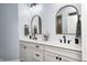 Bathroom featuring double sinks, white cabinetry, gold framed mirrors and matte black fixtures at 11626 Laurel Springs Cir, Noblesville, IN 46060