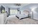 Bright bedroom featuring neutral decor, carpeted floors, a ceiling fan and a large window providing natural light at 11626 Laurel Springs Cir, Noblesville, IN 46060