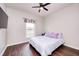 Bedroom with hardwood floors, ceiling fan, and large window letting in natural light at 11626 Laurel Springs Cir, Noblesville, IN 46060