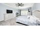 Bright bedroom featuring neutral decor, carpeted floors, a ceiling fan and a large window providing natural light at 11626 Laurel Springs Cir, Noblesville, IN 46060