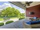 Covered patio with outdoor seating, ceiling fan, rug, and views of the landscaped backyard at 11626 Laurel Springs Cir, Noblesville, IN 46060