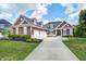 Charming two-story home boasts a manicured lawn and a spacious three-car garage, blending comfort and curb appeal at 11626 Laurel Springs Cir, Noblesville, IN 46060