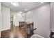 Well-lit hallway with hardwood floors, a decorative vase, and views to other rooms in the house at 11626 Laurel Springs Cir, Noblesville, IN 46060