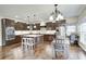 Well-lit kitchen featuring custom cabinets, stainless steel appliances, an island with seating, and a dining area at 11626 Laurel Springs Cir, Noblesville, IN 46060