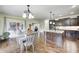 Open-concept kitchen and dining area with hardwood floors and access to the outdoor patio at 11626 Laurel Springs Cir, Noblesville, IN 46060