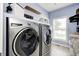 Laundry room equipped with modern, front-loading washer and dryer on a counter surface at 11626 Laurel Springs Cir, Noblesville, IN 46060