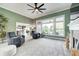 Spacious living room with comfortable seating, a ceiling fan, large windows, and neutral decor at 11626 Laurel Springs Cir, Noblesville, IN 46060