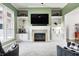 Bright living room with built-in shelving surrounding a fireplace, providing storage and a focal point at 11626 Laurel Springs Cir, Noblesville, IN 46060