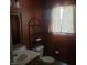 Bathroom featuring red walls, a sink with a mirror, a toilet, and a decorative shelving unit at 11985 Cat Tail Ct, Noblesville, IN 46060