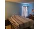 This bedroom features calming blue walls, neutral curtains, and a cozy bed at 11985 Cat Tail Ct, Noblesville, IN 46060