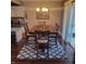 Well-lit dining area featuring a dining table on an area rug and sliding glass door at 11985 Cat Tail Ct, Noblesville, IN 46060