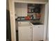 Laundry room with a washer, a dryer, overhead cabinets, and open shelving for storage at 11985 Cat Tail Ct, Noblesville, IN 46060