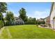 Expansive backyard features mature trees, manicured lawn and outdoor patio perfect for relaxation at 11995 Gray Eagle Dr, Fishers, IN 46037