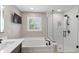 Bathroom featuring a soaking tub, frameless glass shower, and modern finishes at 11995 Gray Eagle Dr, Fishers, IN 46037