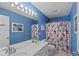Vibrant bathroom featuring double sinks, a large mirror, and a shower with a colorful curtain at 11995 Gray Eagle Dr, Fishers, IN 46037