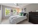 Comfortable bedroom with bright windows, ceiling fan, and dark wood dresser at 11995 Gray Eagle Dr, Fishers, IN 46037