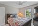 Relaxing bedroom with floral patterned bedding, ceiling fan, and a dark wood dresser at 11995 Gray Eagle Dr, Fishers, IN 46037