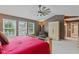 Spacious bedroom featuring a ceiling fan, large windows, and modern decor at 11995 Gray Eagle Dr, Fishers, IN 46037