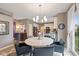 A dining area shows a round table and view into an open kitchen with stainless steel appliances at 11995 Gray Eagle Dr, Fishers, IN 46037