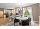 Dining area features a round table, modern chandelier, with kitchen and living spaces in background at 11995 Gray Eagle Dr, Fishers, IN 46037
