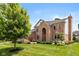 Two-story brick home featuring an arched entryway, manicured lawn, and mature trees providing curb appeal at 11995 Gray Eagle Dr, Fishers, IN 46037
