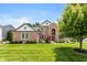 Well-manicured lawn and mature landscaping highlight this two-story brick home, complete with an arched entryway at 11995 Gray Eagle Dr, Fishers, IN 46037