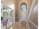 Grand foyer featuring hardwood floors, a staircase, and a large arched window above the front door at 11995 Gray Eagle Dr, Fishers, IN 46037