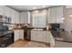 An open, well-lit kitchen with white cabinets, stainless steel appliances and granite countertops at 11995 Gray Eagle Dr, Fishers, IN 46037