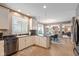 Well-lit kitchen with white cabinets, granite countertops and stainless steel dishwasher at 11995 Gray Eagle Dr, Fishers, IN 46037