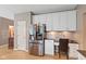 Bright kitchen with white cabinets, stainless steel refrigerator, and desk area with granite countertop at 11995 Gray Eagle Dr, Fishers, IN 46037