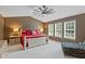 Spacious main bedroom with a vaulted ceiling, comfortable chair and three large windows at 11995 Gray Eagle Dr, Fishers, IN 46037