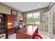 Home office with a large desk, built-in bookcase, and natural light at 11995 Gray Eagle Dr, Fishers, IN 46037