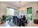 Bright dining room with large windows, modern light fixture, and seating for up to six people at 1311 Central Ave, Indianapolis, IN 46202