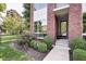 Close-up of a stylish brick home featuring decorative landscaping and a welcoming front entrance at 1311 Central Ave, Indianapolis, IN 46202