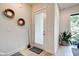Modern foyer featuring a frosted glass door, sleek light fixtures, and a beautiful plant accent at 1311 Central Ave, Indianapolis, IN 46202