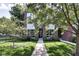 Inviting two-story brick home with manicured lawn and lush landscaping creates stunning curb appeal at 1311 Central Ave, Indianapolis, IN 46202